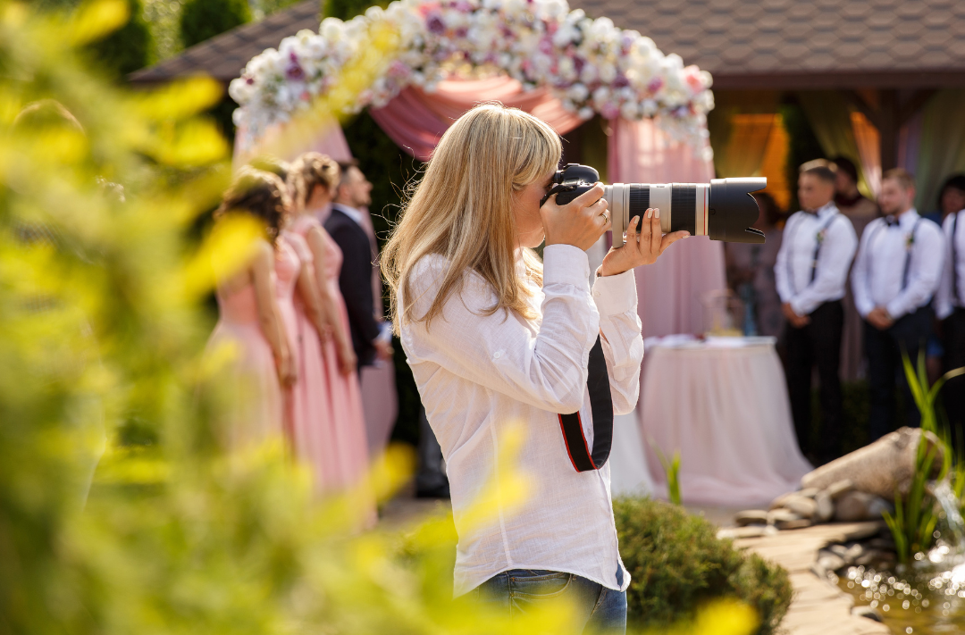 Photographer capturing a wedding ceremony